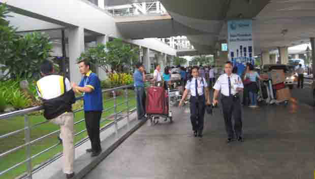 Departing passengers outside Ninoy Aquino International airport terminal