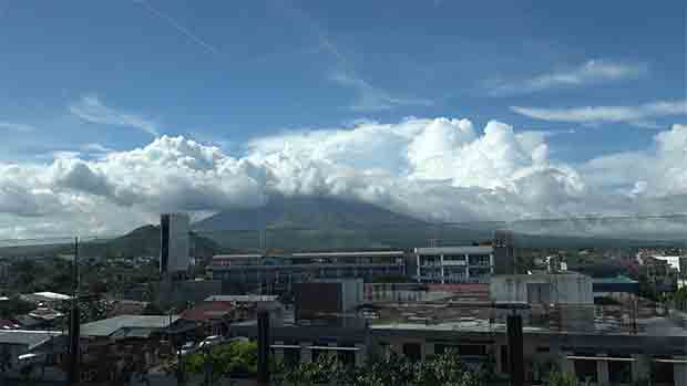 Cloud shrouded Mt. Mayon as viewed from the Food Court of SM City Legazpi. Who needs a new convention center only to view the almost perfect coned volcano?